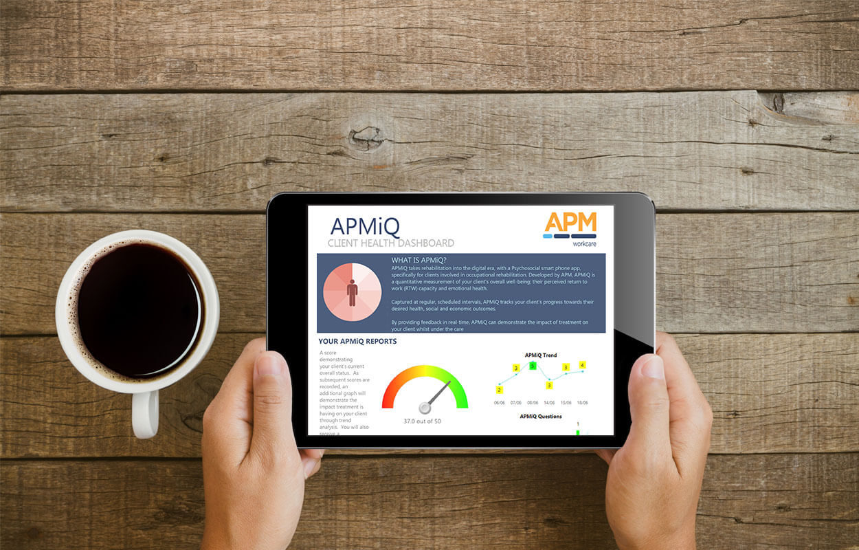 APM information on an ipad next to a cup of coffee
